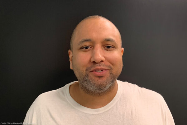 Mikal Mahdi headshot wearing a white tee shirt.